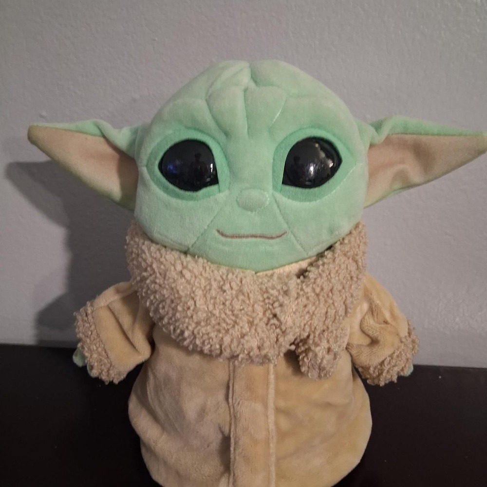 Star Wars baby yoda plush toy with green face and beige robe